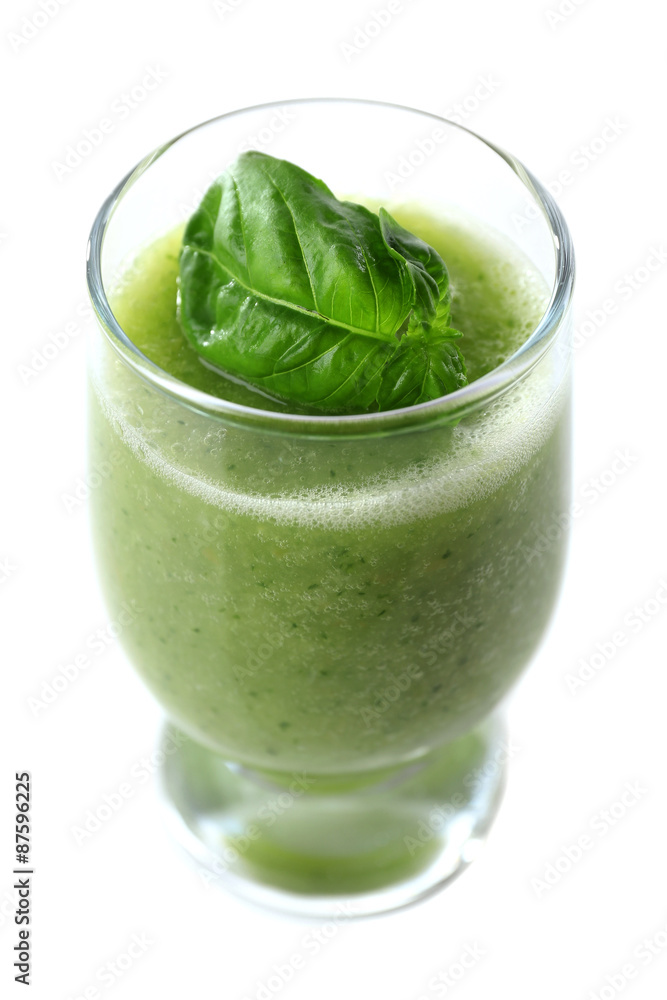 Glass of green healthy juice with basil isolated on white Glass of green healthy juice with basil isolated on white