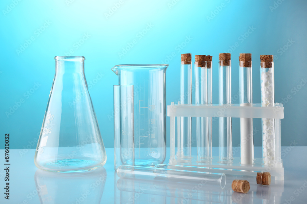 Empty laboratory test tubes on blue background Empty laboratory test tubes on blue background