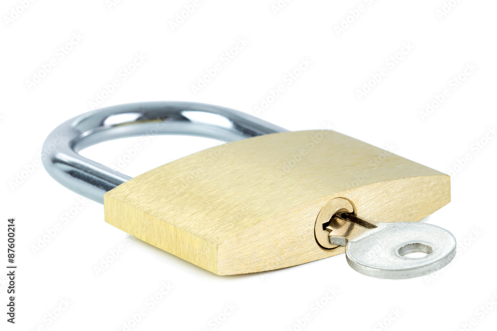 Close-up of a locked padlock with a key in the keyhole, isolated on white background Close-up of a locked padlock with a key in the keyhole, isolated on white background