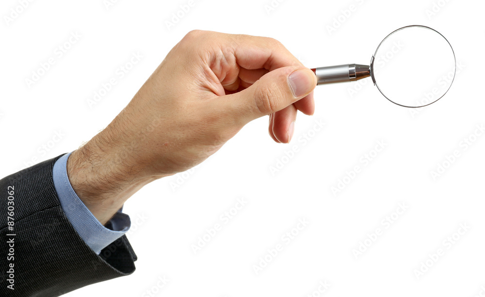 Male hand holding magnifying glass isolated on white Male hand holding magnifying glass isolated on white