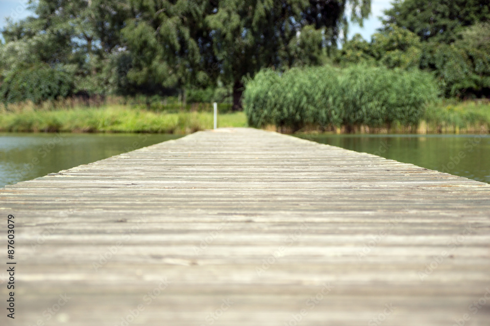 wooden footbridge / old wooden footbridge over a pond