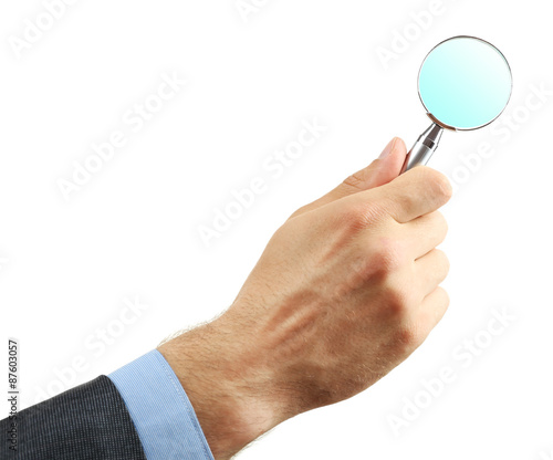 Male hand holding magnifying glass isolated on white