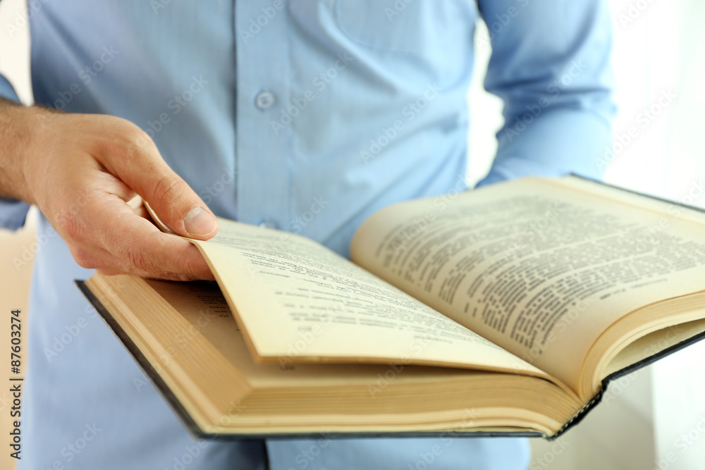 Young man reading book close up Young man reading book close up