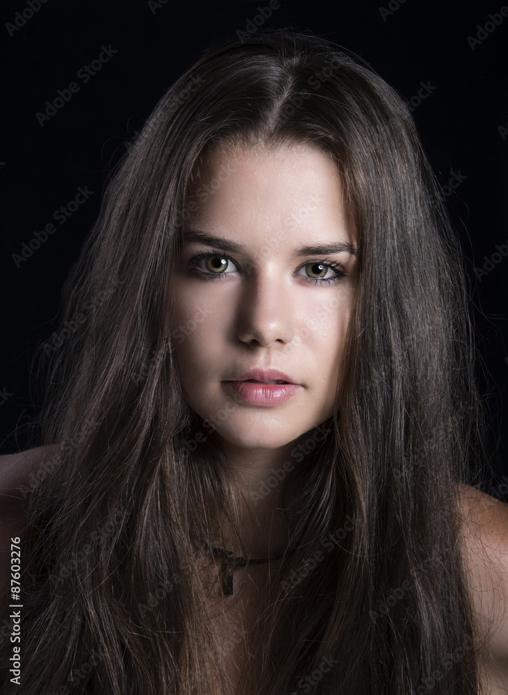 Fototapeta premium Beautiful brunette woman with long hair posing at studio