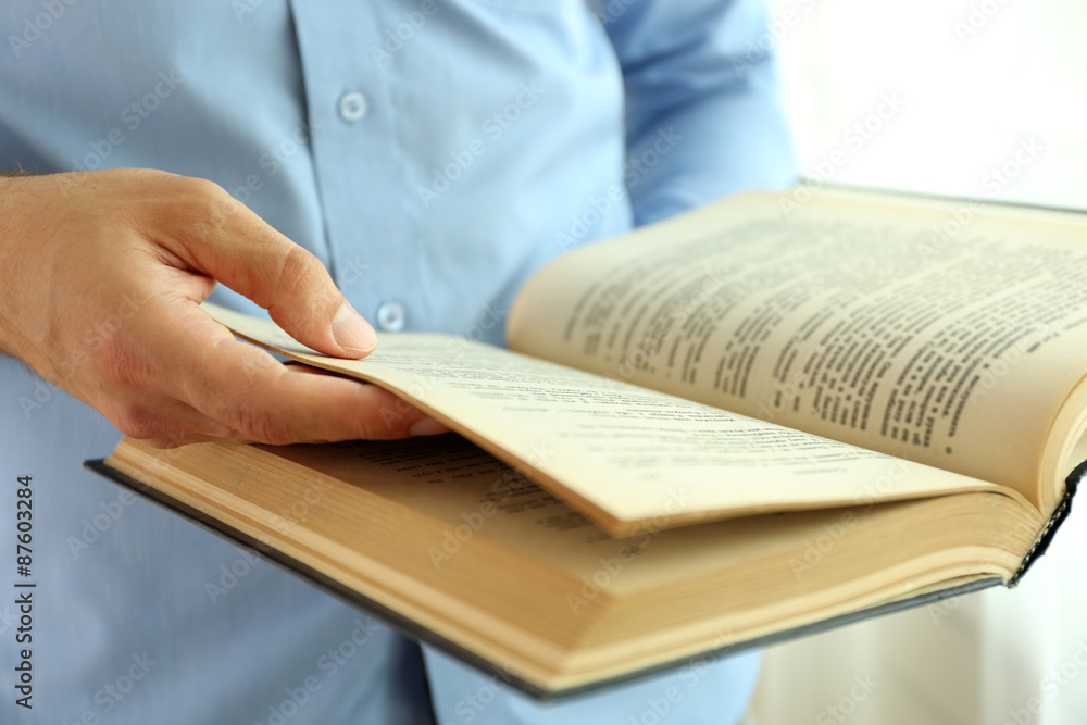 Young man reading book close up Young man reading book close up