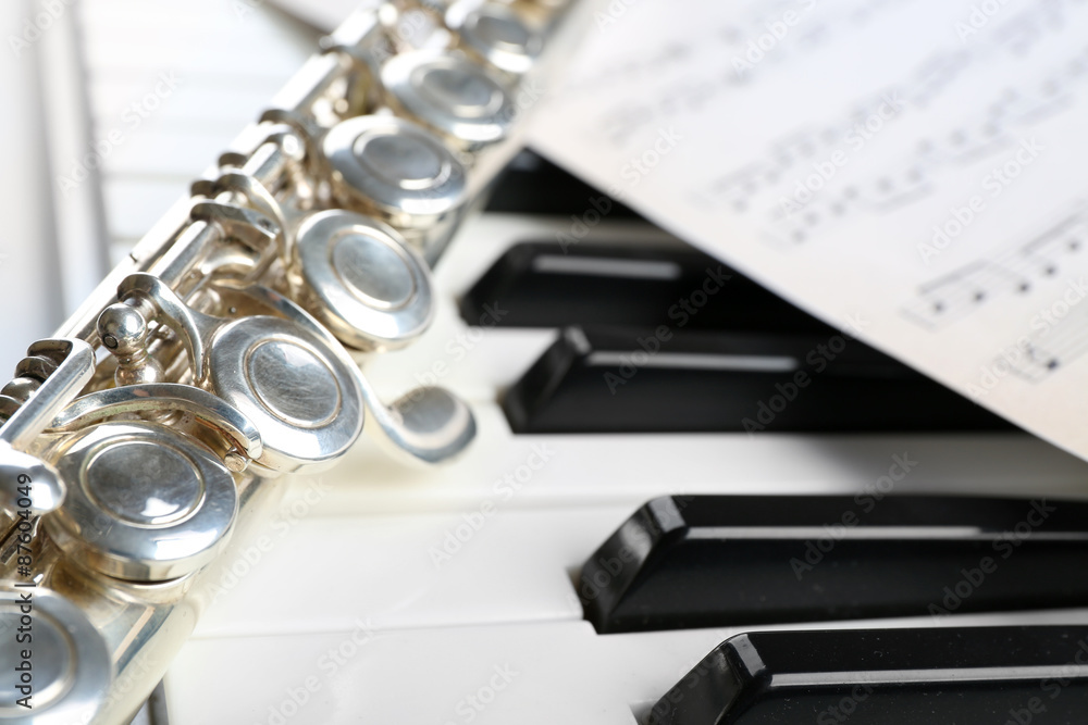 Fototapeta premium Flute and piano with music sheet close up