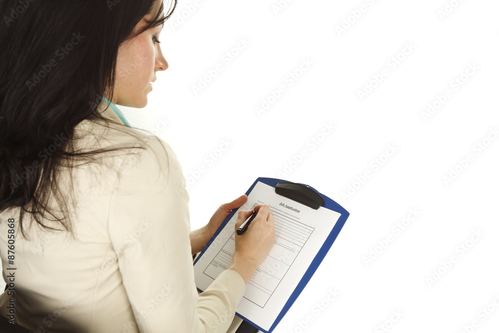 Young woman filling out job application. Focus is on application. Young woman filling out job application. Focus is on application.