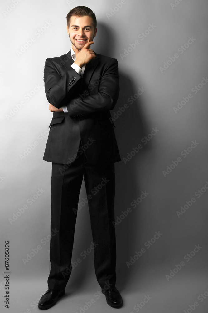 Handsome businessman on gray background Handsome businessman on gray background