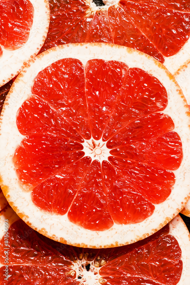 Slices of red grapefruit, top view, selective focus Slices of red grapefruit, top view, selective focus