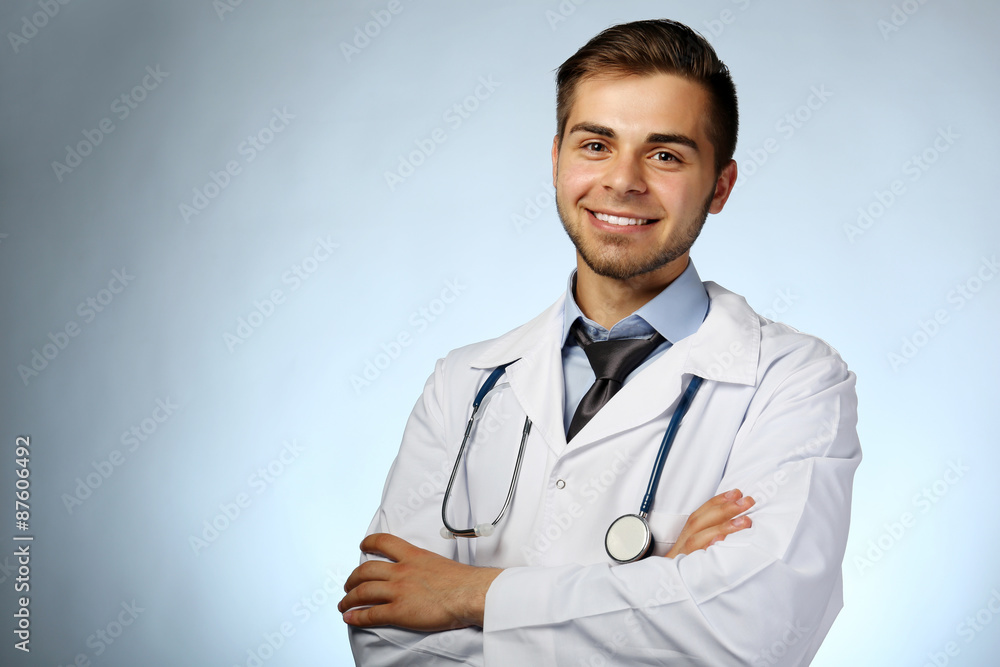 Male doctor with stethoscope on blue background Male doctor with stethoscope on blue background