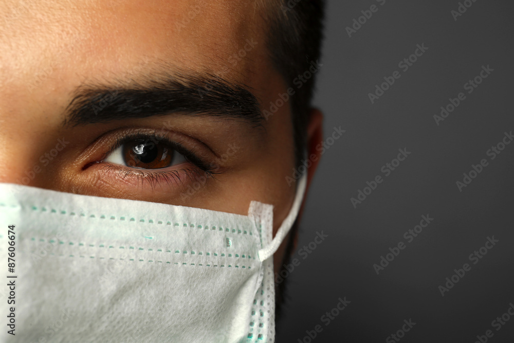 Young male doctor on gray background Young male doctor on gray background