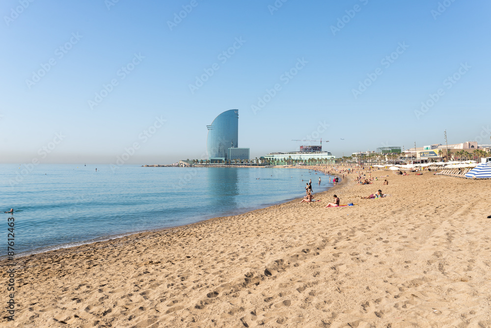 Fototapeta premium The beach of Barceloneta early morning. In the background the huge Barcelona-W hotel. The beach is in close to down town and very famous in Barcelona