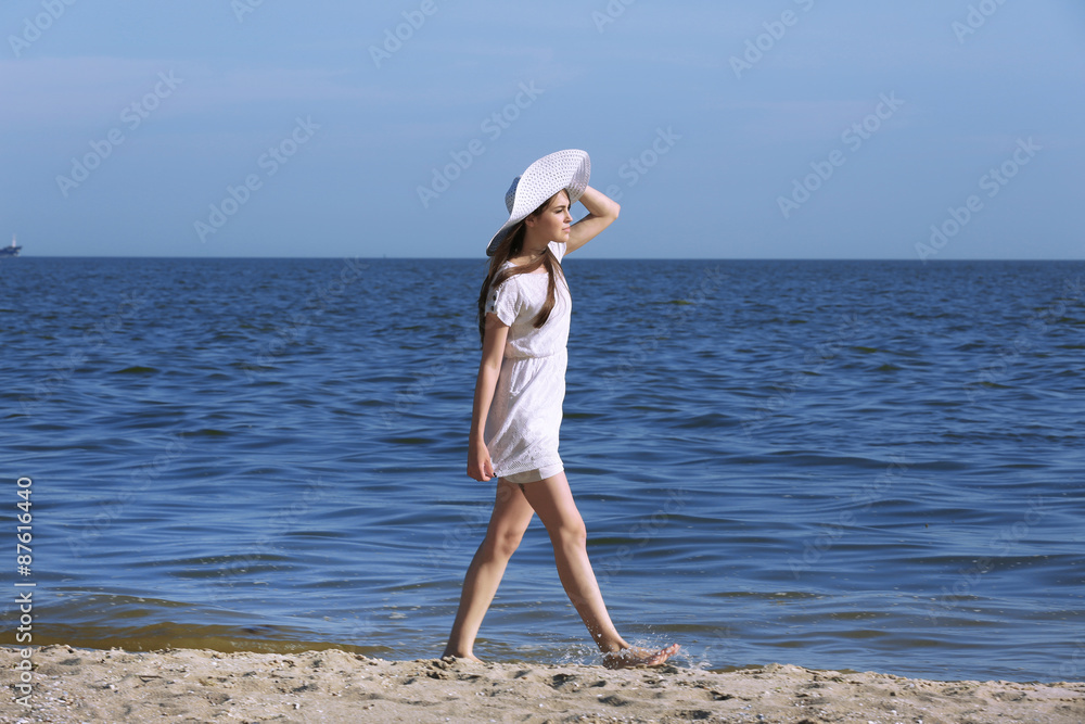 Pretty woman walking on beach
