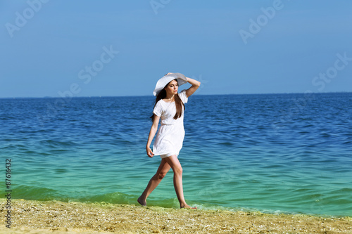 Pretty woman walking on beach