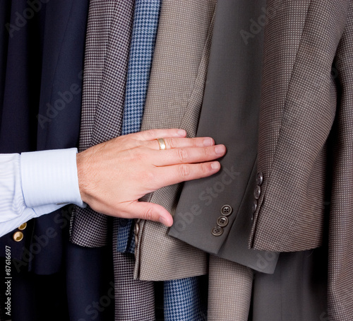 Man searching through suits