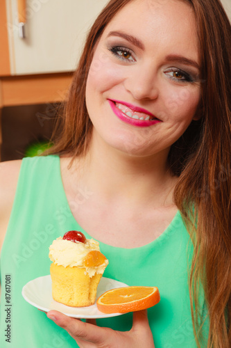 Woman holding delicious sweet cake. Gluttony.