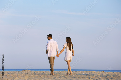 Young couple walking on beach