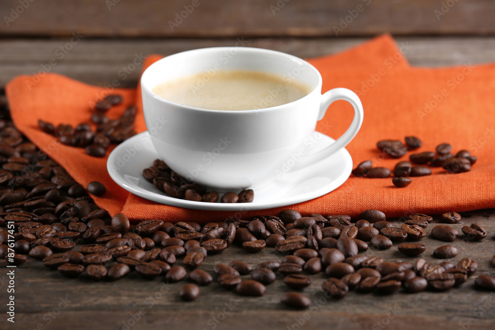 Cup of coffee and beans on table close up Cup of coffee and beans on table close up