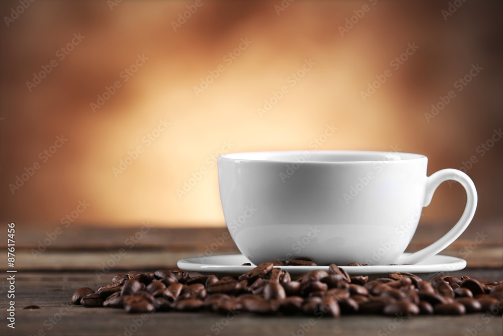 Cup of coffee and beans on blurred background Cup of coffee and beans on blurred background