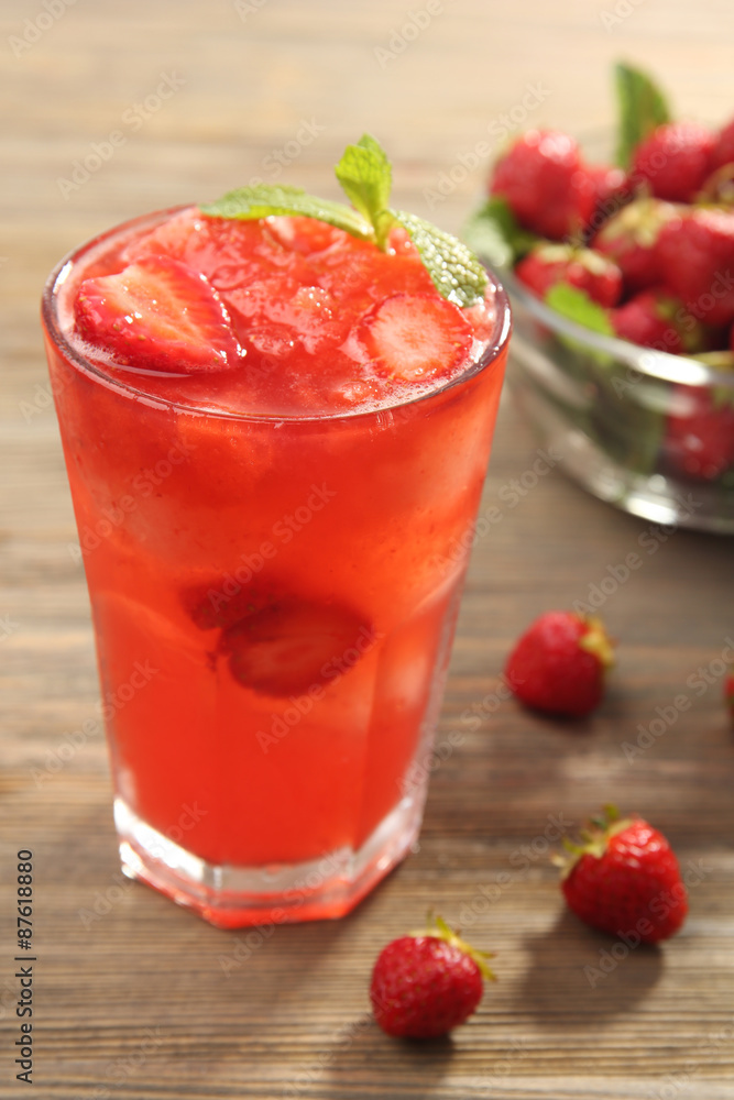 Glasses of strawberry juice with berries on table close up Glasses of strawberry juice with berries on table close up