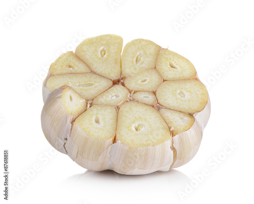 Head of garlic cut in half on white background