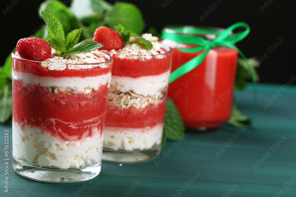 Dessert with fresh strawberry, cream and granola, on color wooden table background Dessert with fresh strawberry, cream and granola, on color wooden table background
