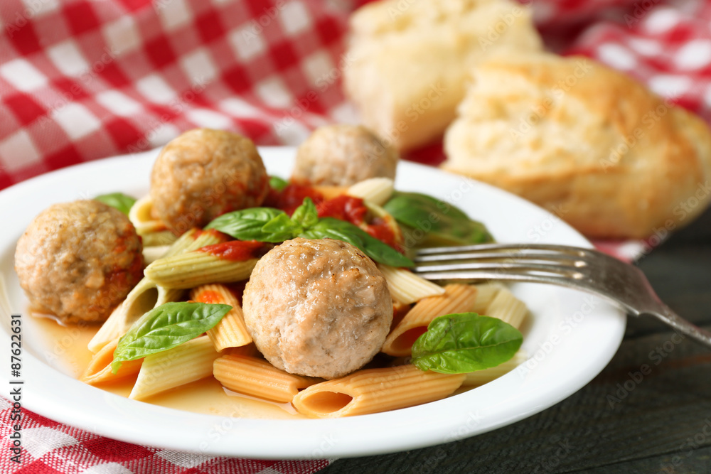 Pasta with meatballs on plate, on wooden table background Pasta with meatballs on plate, on wooden table background
