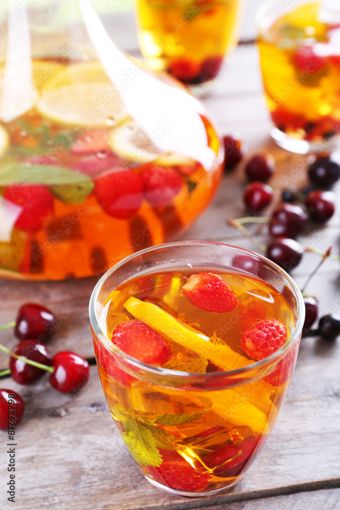 Punch with berries in glassware on wooden table, closeup Punch with berries in glassware on wooden table, closeup