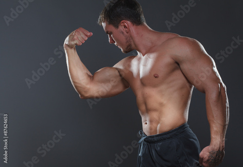 Bodybuilder showing his back and biceps muscles, personal fitnes