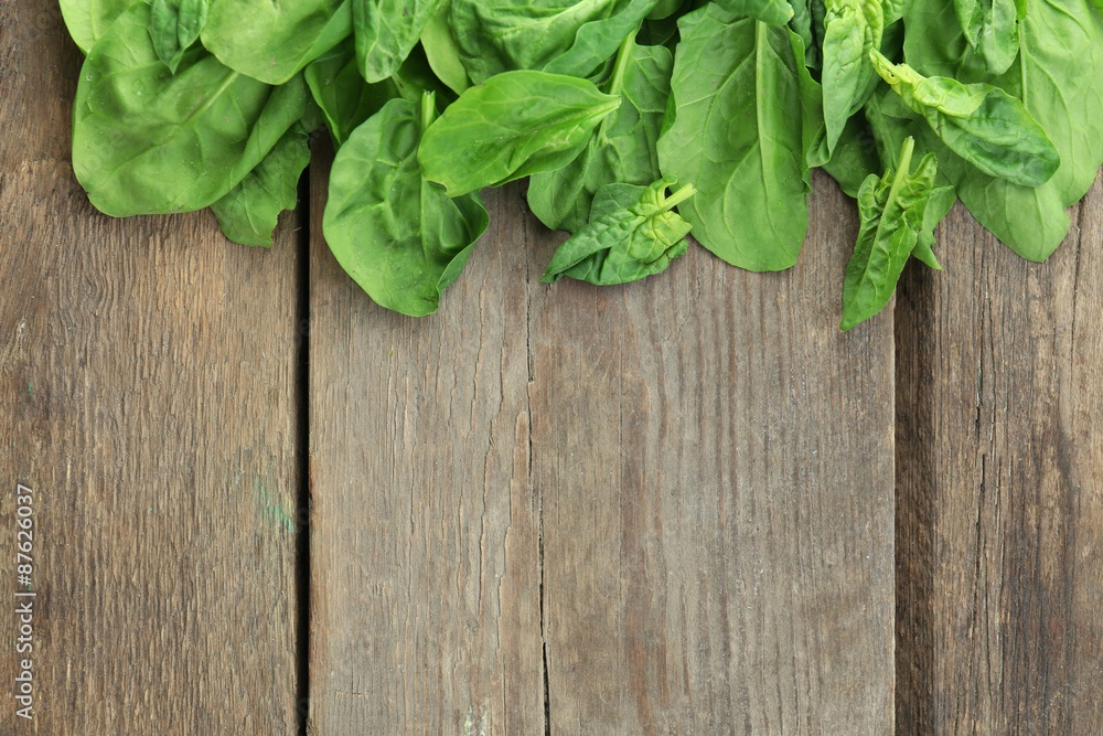 Frame of fresh spinach leaves on wooden background Frame of fresh spinach leaves on wooden background