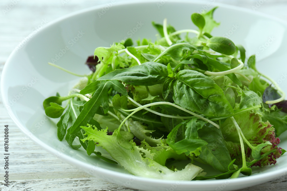 Fresh mixed green salad in bowl close up Fresh mixed green salad in bowl close up