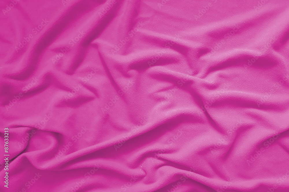 Creased pink cloth material fragment as a background Creased pink cloth material fragment as a background