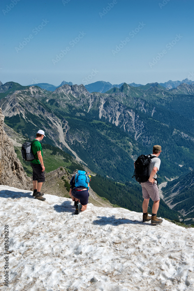 Three climbers on top of Kalter Winkel, Alps