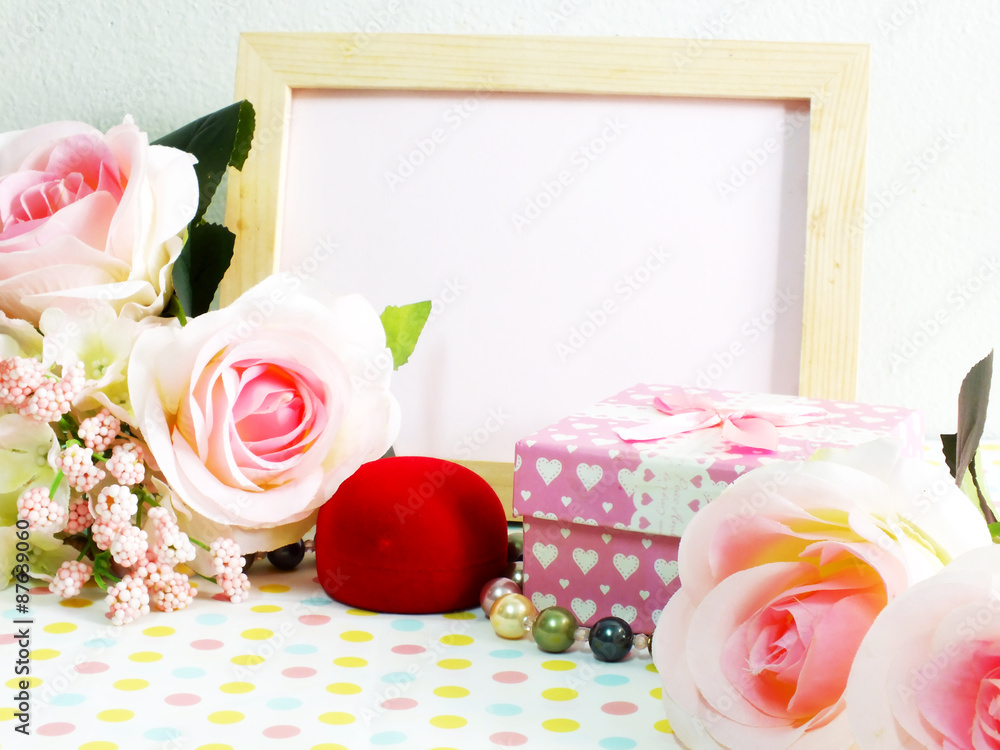 blank photo wood frame with pink roses and gift box on sweet flower