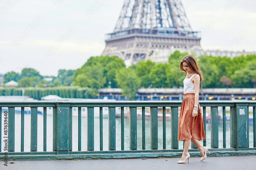 Beautiful young Parisian woman near the Eiffel tower