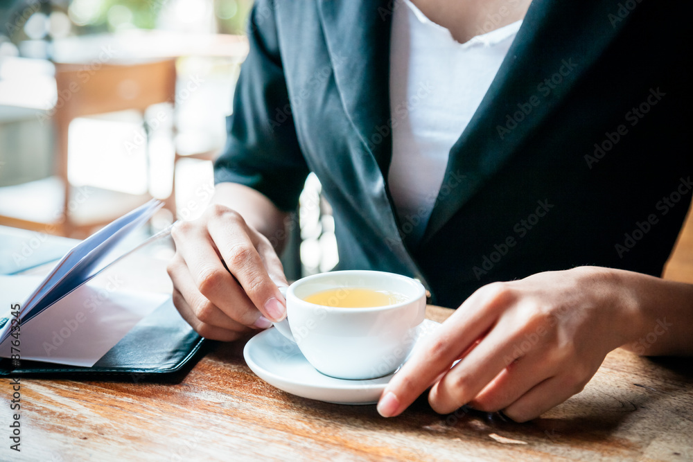 close up of woman drinking tea while sitting close up of woman drinking tea while sitting