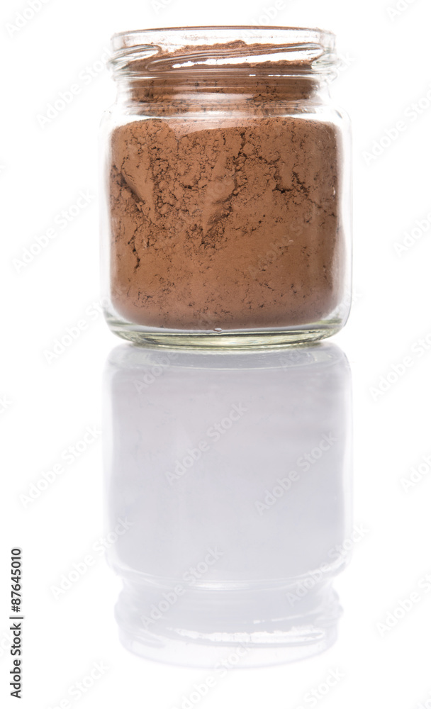 Brown pure cocoa powder in a mason jar over white background