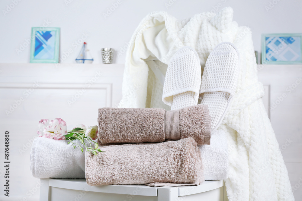 Bath set with white bathrobe on chair, indoors - obrazy, fototapety, plakaty 
