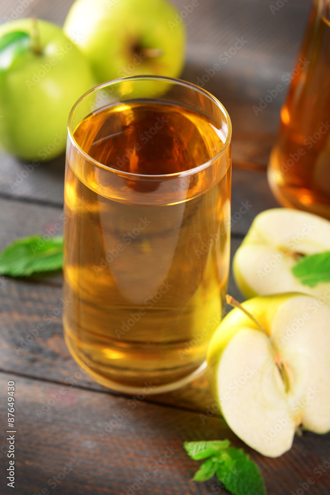 Glasses of apple juice on wooden table, closeup Glasses of apple juice on wooden table, closeup