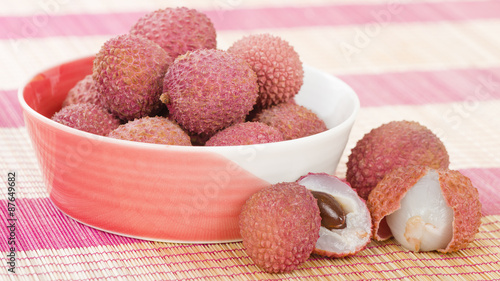 Lychees - Fresh lychees in a pink bowl.
