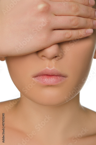 woman shields her eyes from hand