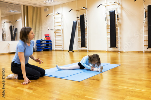 Child, a girl is engaged in ballet, gymnastics, yoga in the gym