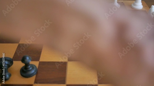 Scattering chess pieces while playing chess photo