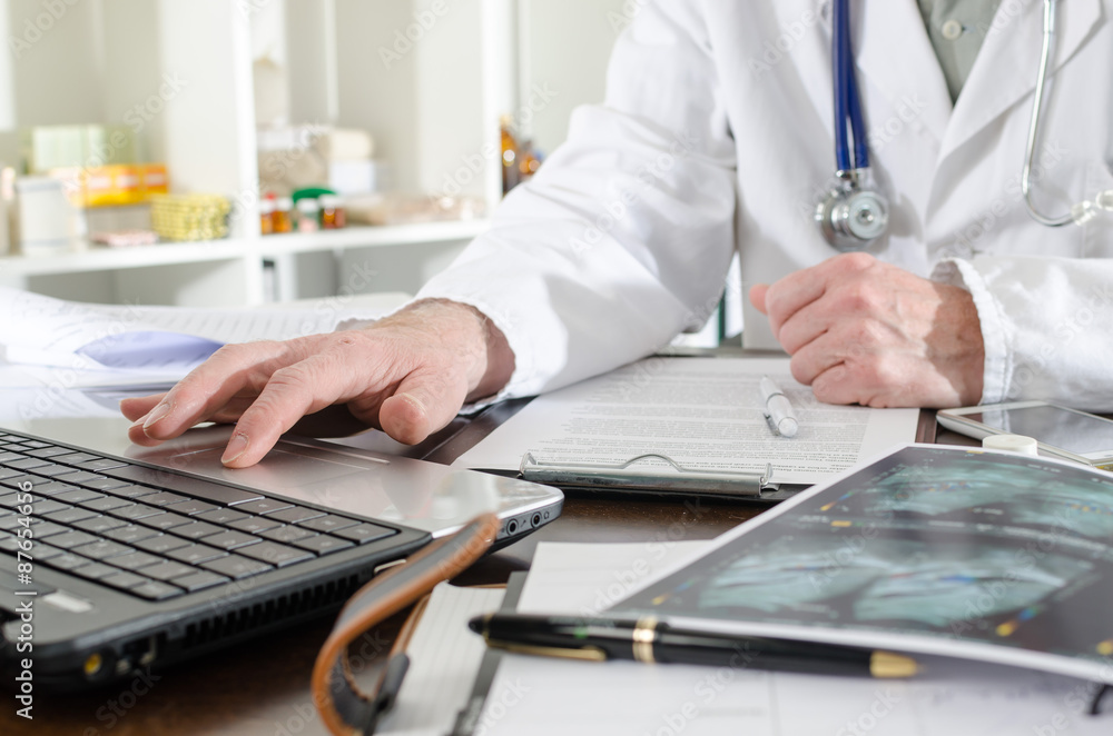 Doctor using a laptop Doctor using a laptop