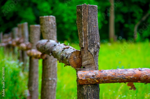 Wooden fence made of logs