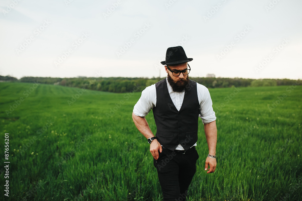 man with a beard and sunglasses walking on the field man with a beard and sunglasses walking on the field
