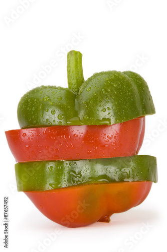 Green and Red Bell Pepper Slices – Green and red bell pepper slices, sliced and alternated. On a white background. © Cathleen