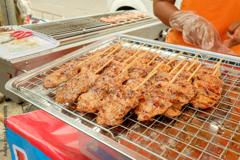 Street food traditional thai style grilled pork.