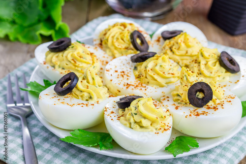 Obraz na płótnie Spicy deviled eggs garnished with olives