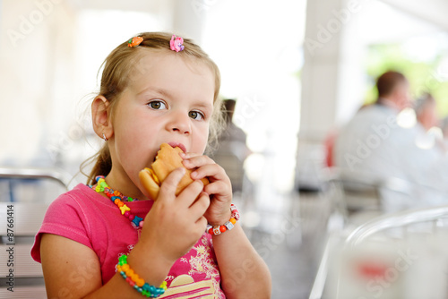 little girl with a hamburger